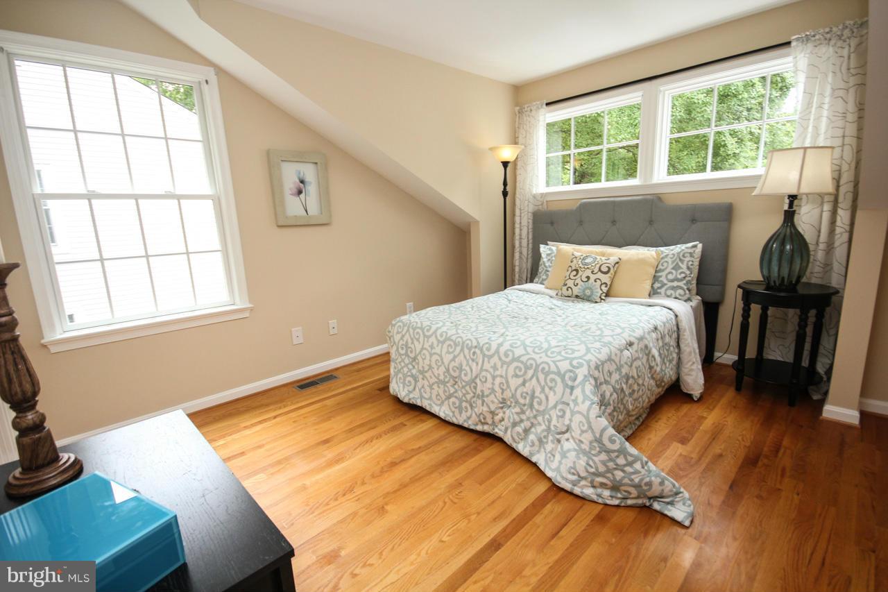 1429 Winding Waye Lane Silver Spring, MD 20902 - Photo 23 of 30 a bedroom with a bed and wooden floor