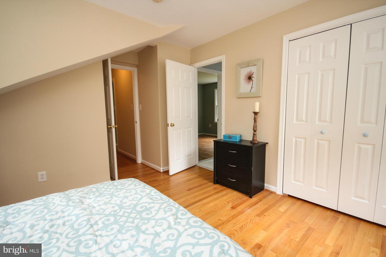 1429 Winding Waye Lane Silver Spring, MD 20902 - Photo 24 of 30 a bedroom with a bed and wooden floor