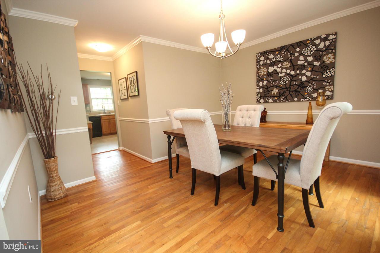 1429 Winding Waye Lane Silver Spring, MD 20902 - Photo 6 of 30 a view of a dining room with furniture wooden floor and chandelier