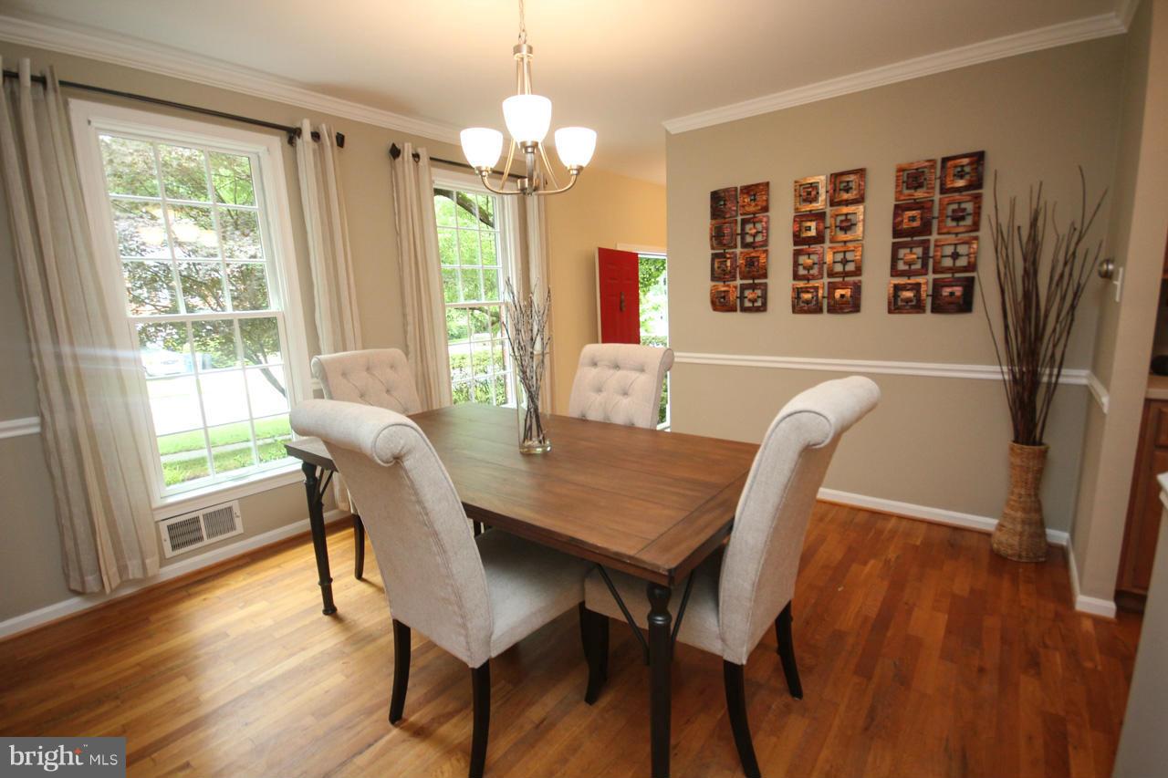 1429 Winding Waye Lane Silver Spring, MD 20902 - Photo 7 of 30 a view of a dining room with furniture window and wooden floor