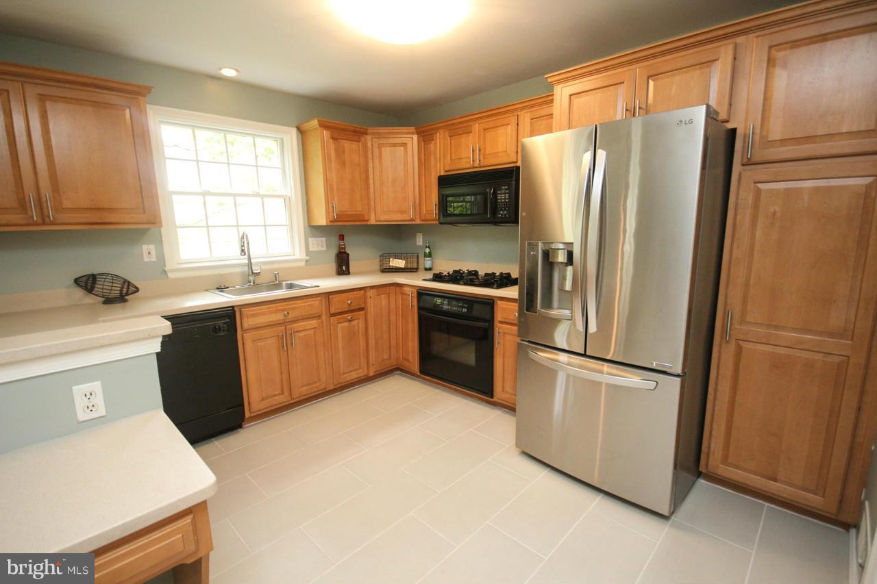 1429 Winding Waye Lane Silver Spring, MD 20902 - Photo 8 of 30 a kitchen with a refrigerator sink and window