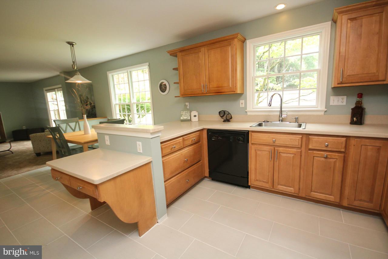 1429 Winding Waye Lane Silver Spring, MD 20902 - Photo 9 of 30 a kitchen with a sink stove and cabinets