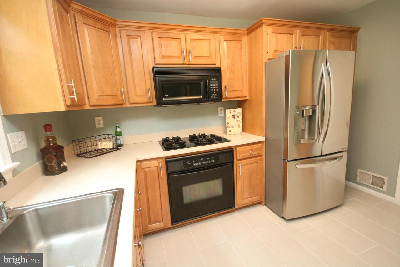 1429 Winding Waye Lane Silver Spring, MD 20902 - Photo 10 of 30 a kitchen with stainless steel appliances granite countertop a refrigerator a stove top oven a sink and dishwasher