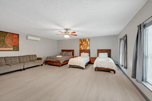 a bedroom with furniture and a chandelier