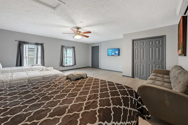 a bedroom with a large bed and a window