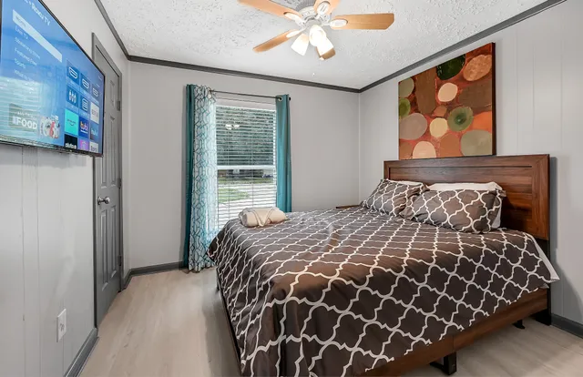 a bed sitting in a bedroom next to a window