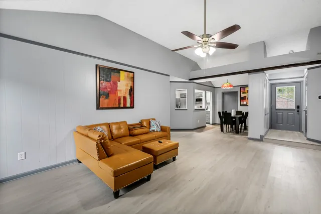 a living room with furniture and wooden floor