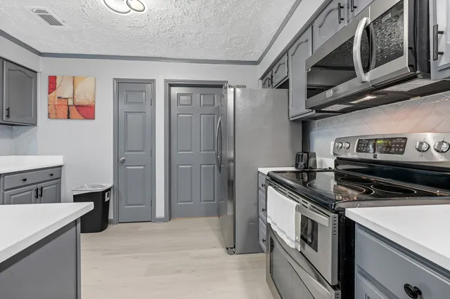 a kitchen with a stove and a microwave