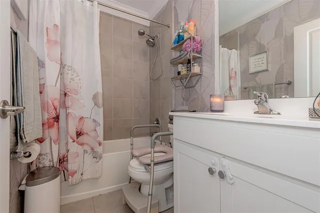 a bathroom with a sink toilet vanity and shower