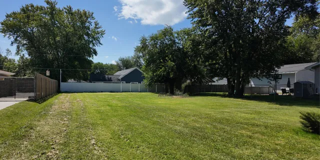 a backyard of a house with yard and trampoline