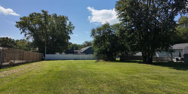 a view of a garden with wooden fence
