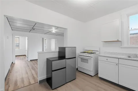 a kitchen with cabinets and steel stainless steel appliances