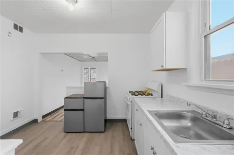 a kitchen with sink and cabinets
