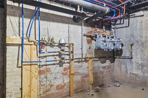 a store room with water heater and outdoor space