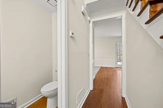 a view of a hallway with toilet and shower