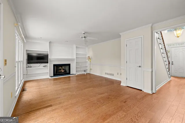 a view of empty room with a fireplace and fan