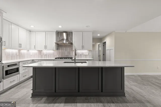 a kitchen with stainless steel appliances granite countertop a sink counter space and cabinets