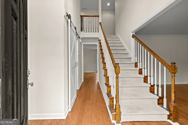 a view of staircase with wooden floor and a rug