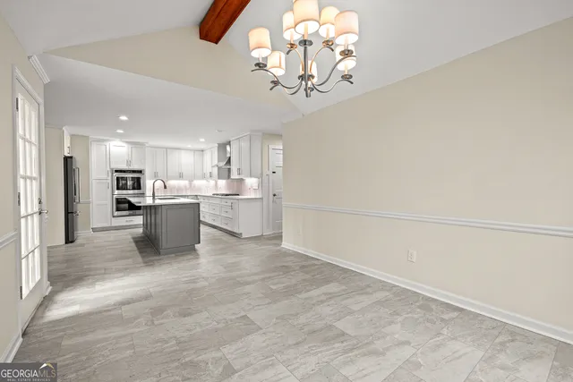 a view of a kitchen with a sink and stainless steel appliances