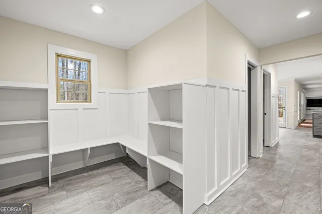 a view of walk in closet with empty racks