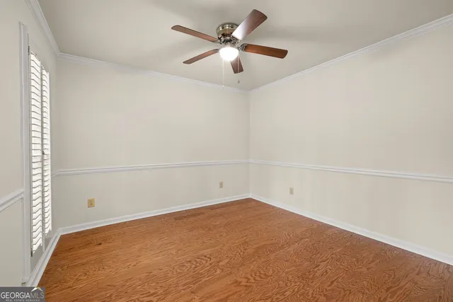 an empty room with a empty space and a ceiling fan