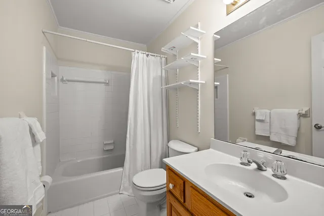 an empty room with windows and chandelier fan