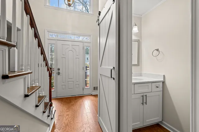 a view of front door with hallway and stairs