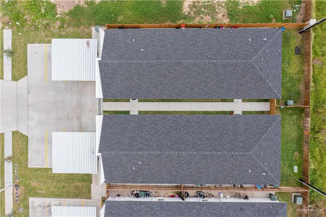 an aerial view of a house with a yard