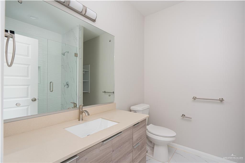 221 Rafael Drive, Unit 1 San Juan, TX 78589 - Photo 10 of 18 a bathroom with a sink and a toilet