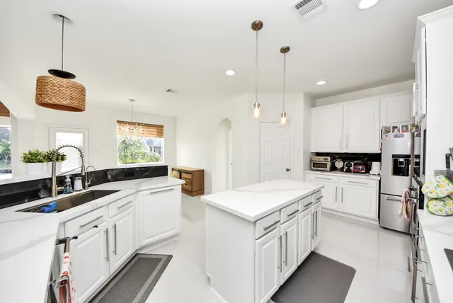 a kitchen with a sink stove and cabinets