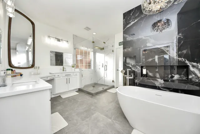 a large bathroom with a double vanity sink a mirror and a bathtub