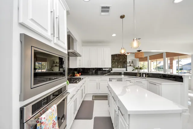 a kitchen with a stove a sink and a microwave