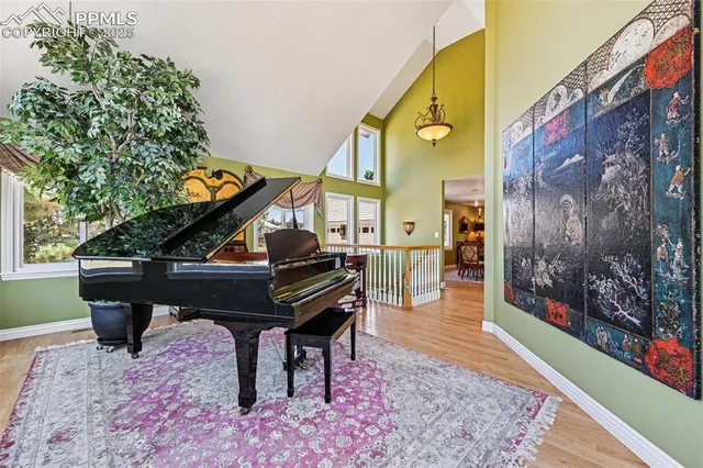 a kitchen with granite countertop a stove a sink and a dining table chairs