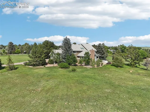 a view of a house with backyard porch and sitting area