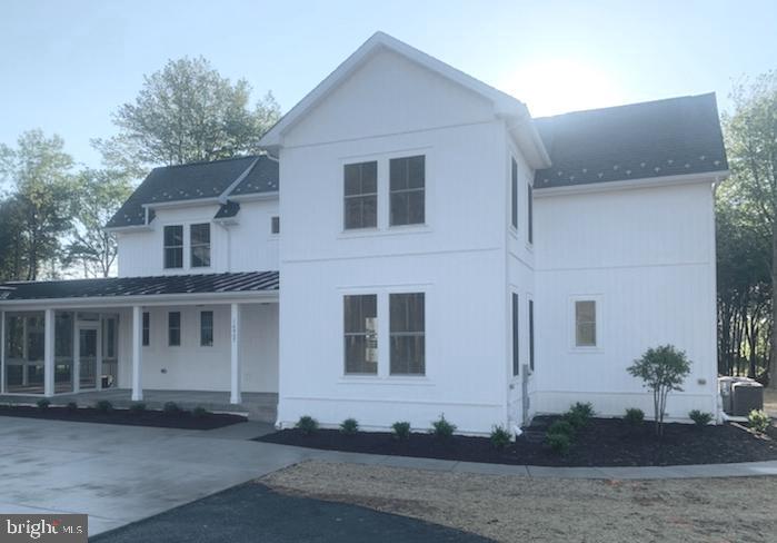 16907 Hughes Road Poolesville, MD 20837 - Photo 1 of 3 a front view of a house with a yard