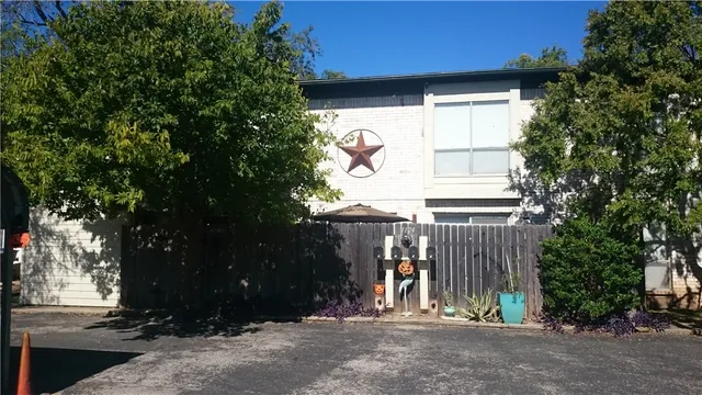 a view of entrance gate of house and trees