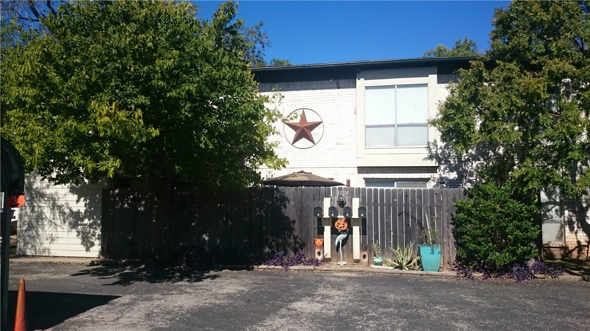 a view of entrance gate of house and trees