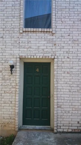 a view of a brick wall and an empty room