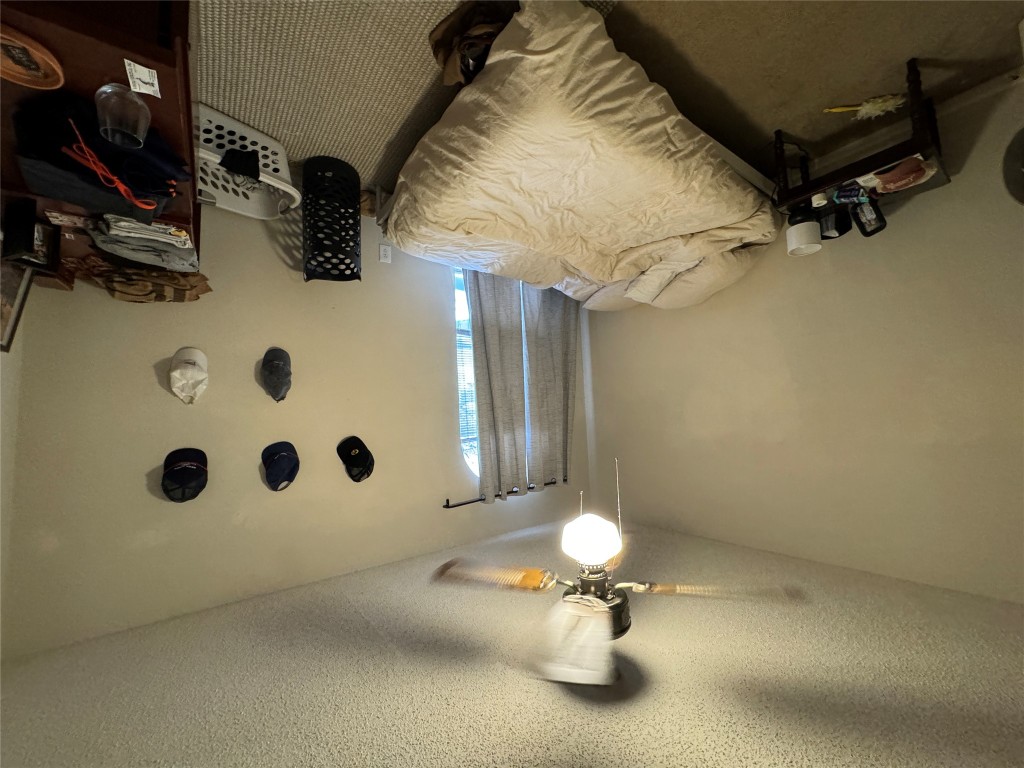 Undisclosed Address Austin, TX 78704 - Photo 10 of 10 a bedroom with a bed and a chandelier