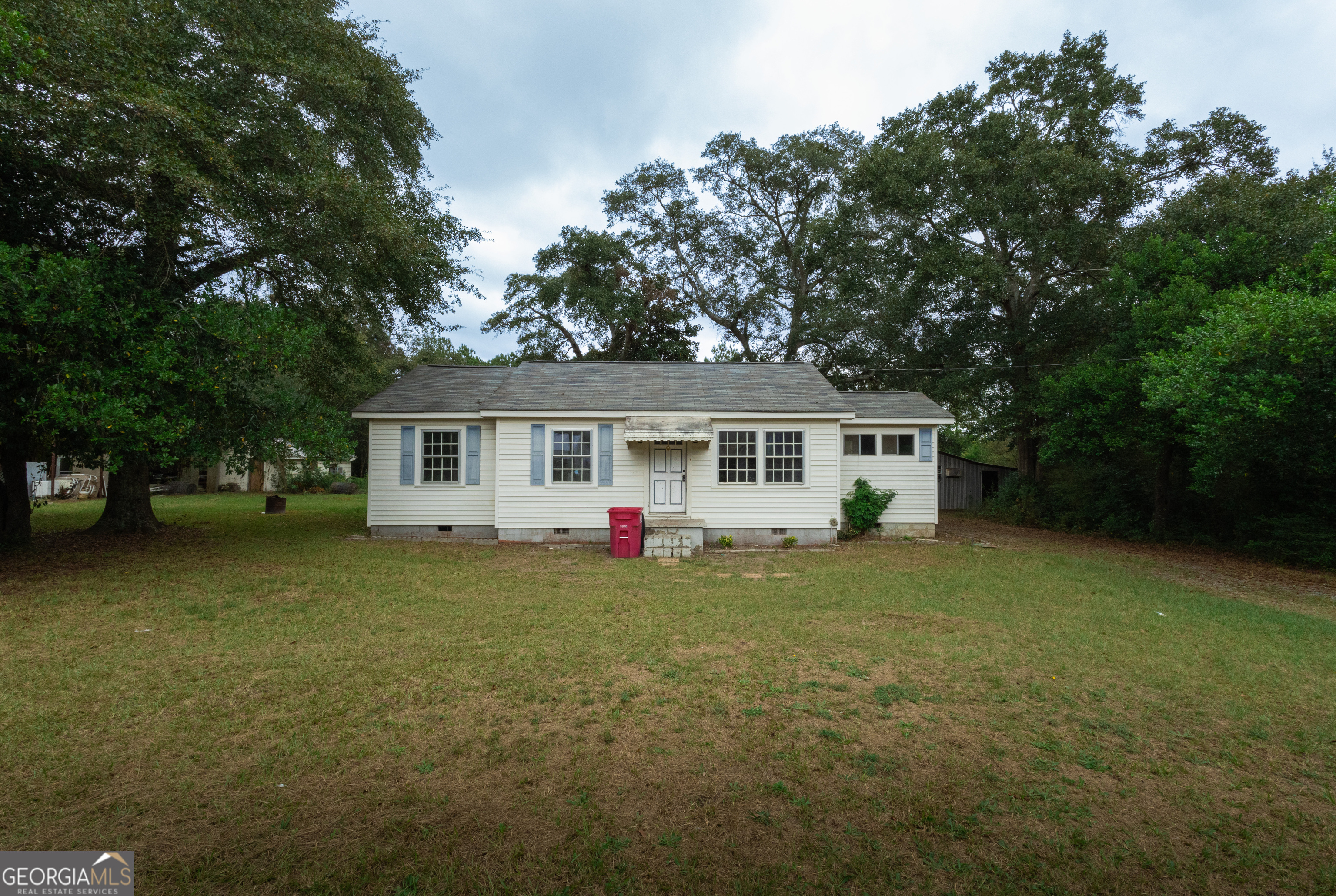a view of a house with a backyard and a tree