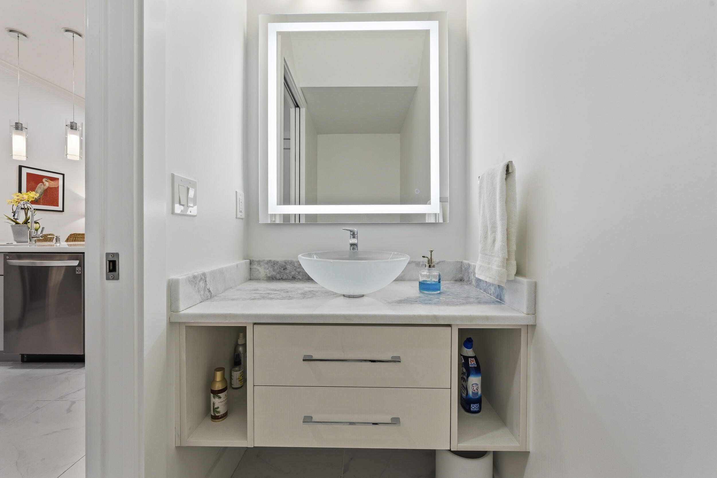 4692 Southeast Manatee Terrace Stuart, FL 34997 - Photo 11 of 47 a bathroom with a granite countertop sink and a mirror