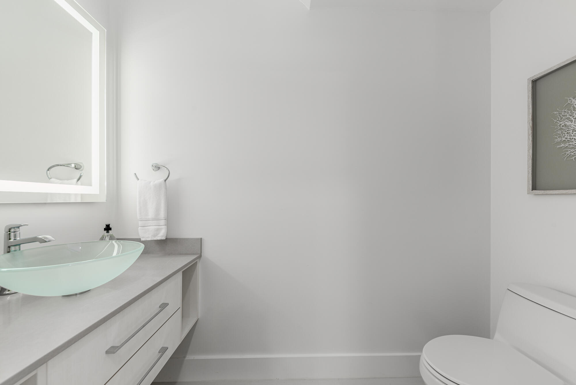 4692 Southeast Manatee Terrace Stuart, FL 34997 - Photo 12 of 47 a bathroom with a sink toilet and vanity