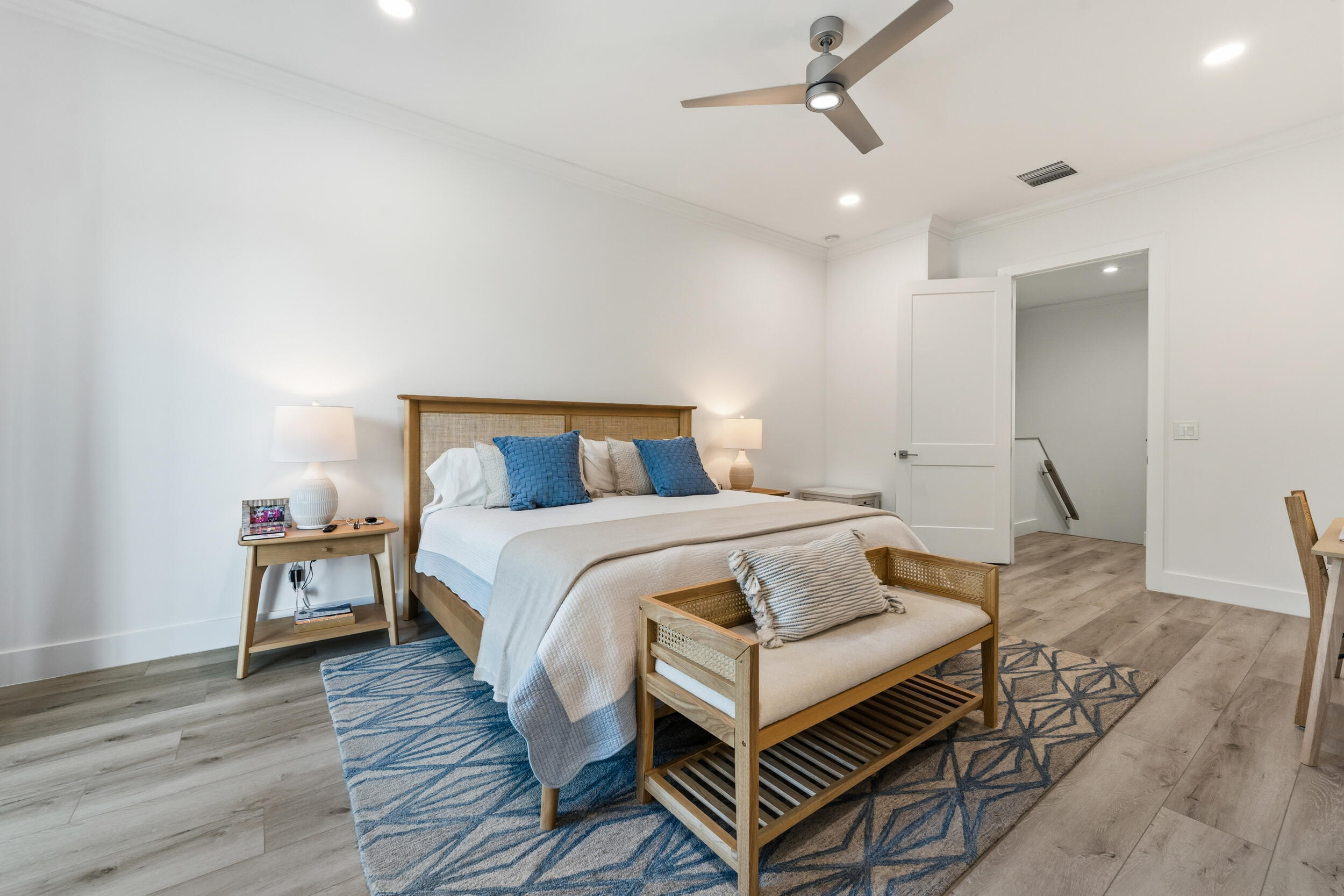 4692 Southeast Manatee Terrace Stuart, FL 34997 - Photo 17 of 47 a bedroom with a bed and wooden floor