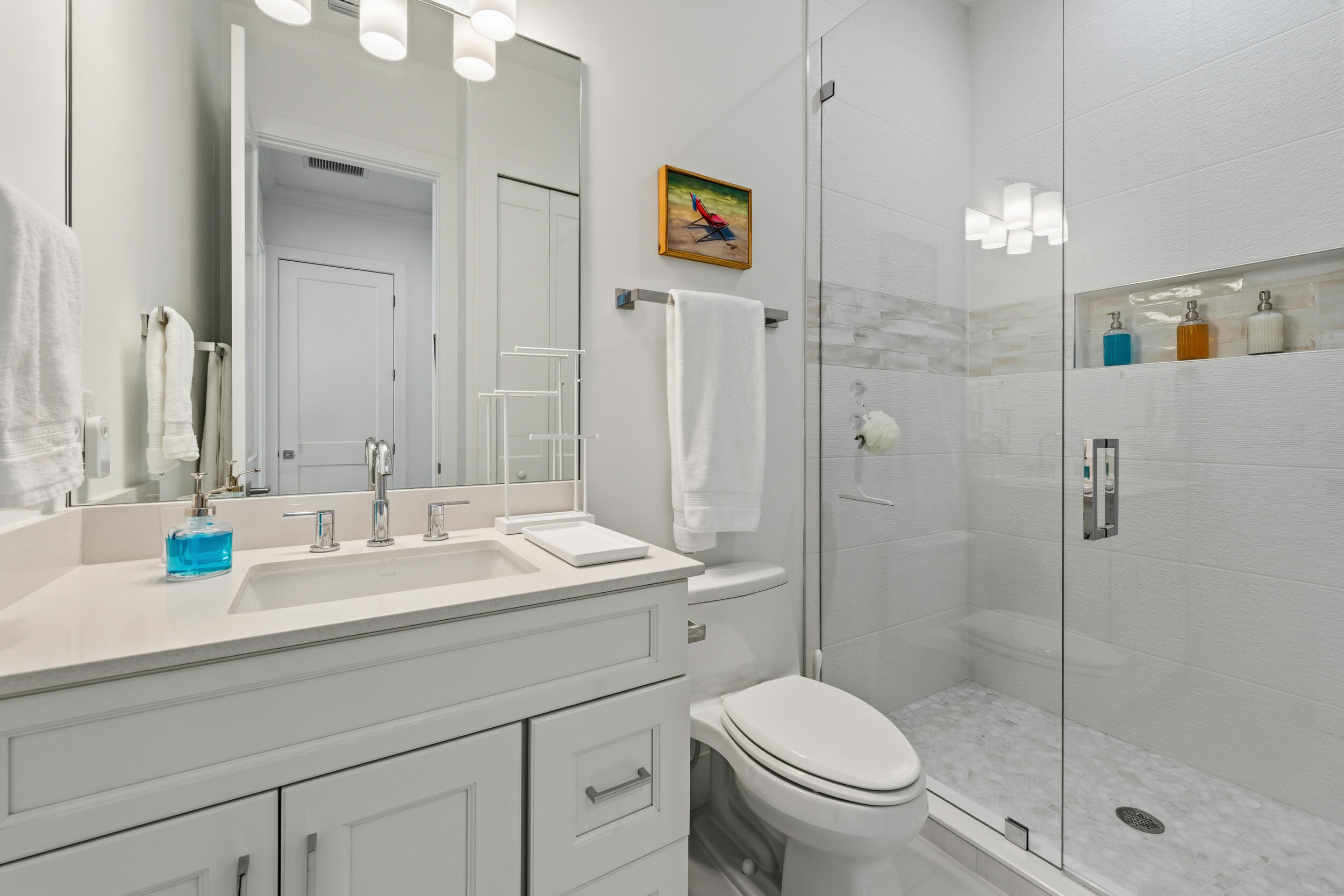 4692 Southeast Manatee Terrace Stuart, FL 34997 - Photo 22 of 47 a bathroom with a sink a toilet and shower