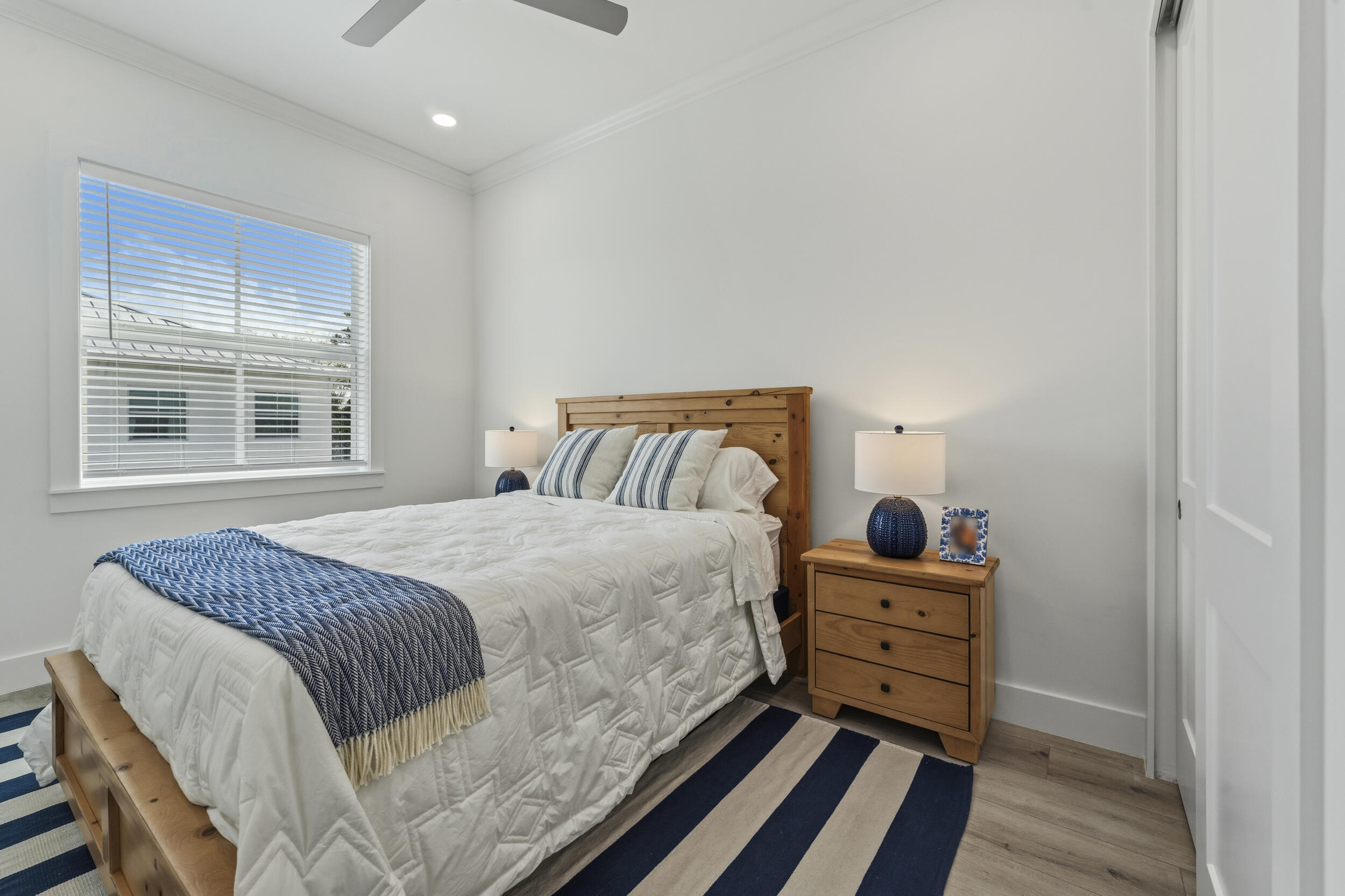 4692 Southeast Manatee Terrace Stuart, FL 34997 - Photo 23 of 47 a bedroom with a bed and wooden floor