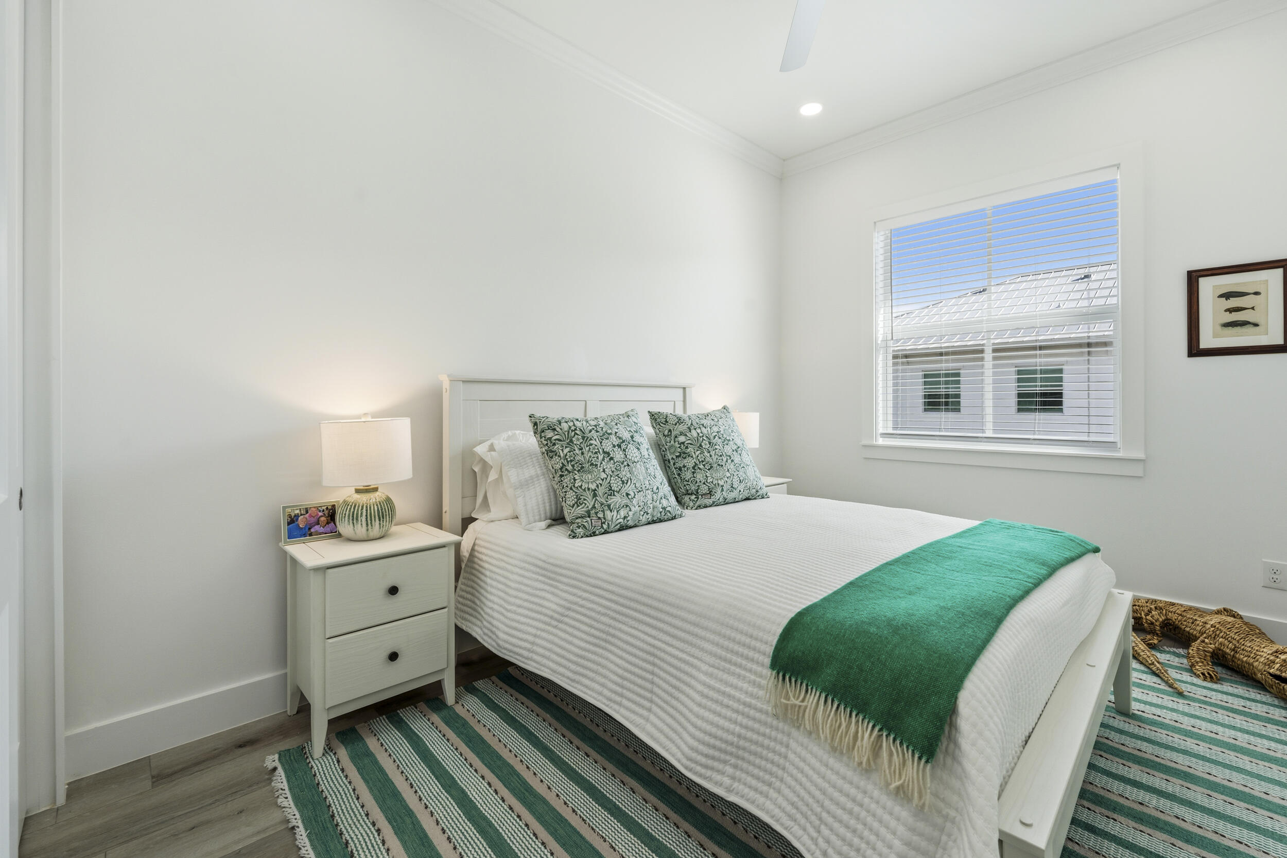 4692 Southeast Manatee Terrace Stuart, FL 34997 - Photo 24 of 47 a bedroom with a bed and wooden floor