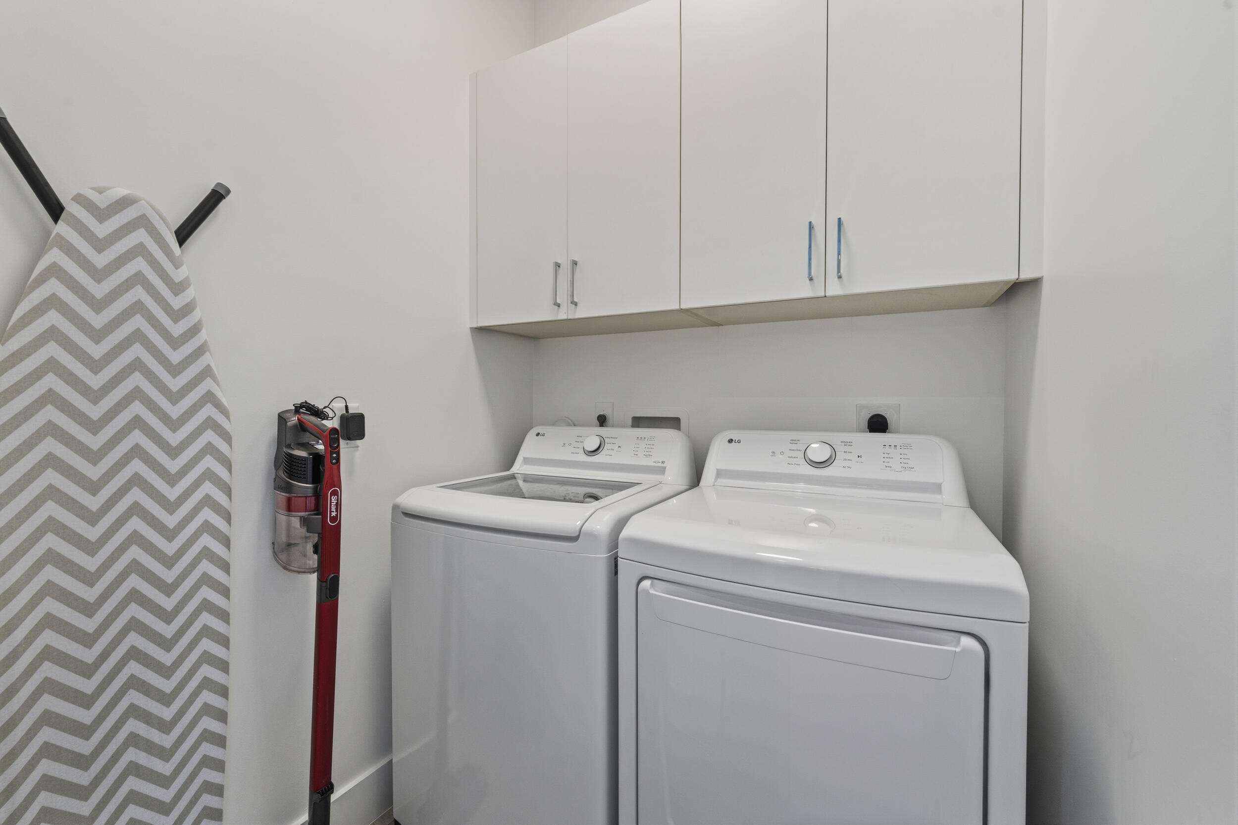 4692 Southeast Manatee Terrace Stuart, FL 34997 - Photo 25 of 47 a utility room with dryer and washer
