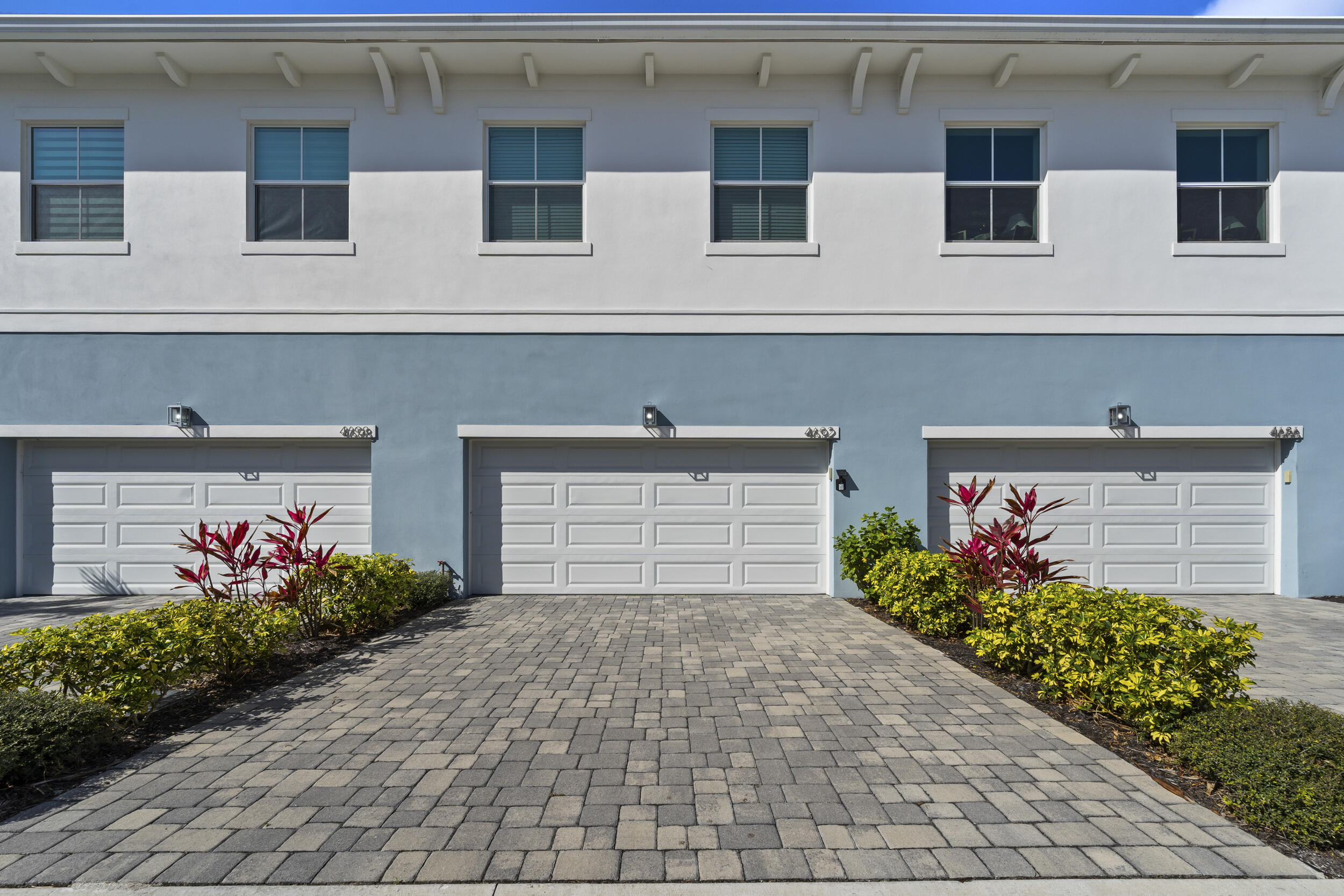 4692 Southeast Manatee Terrace Stuart, FL 34997 - Photo 31 of 47 a front view of a house with a yard and potted plants