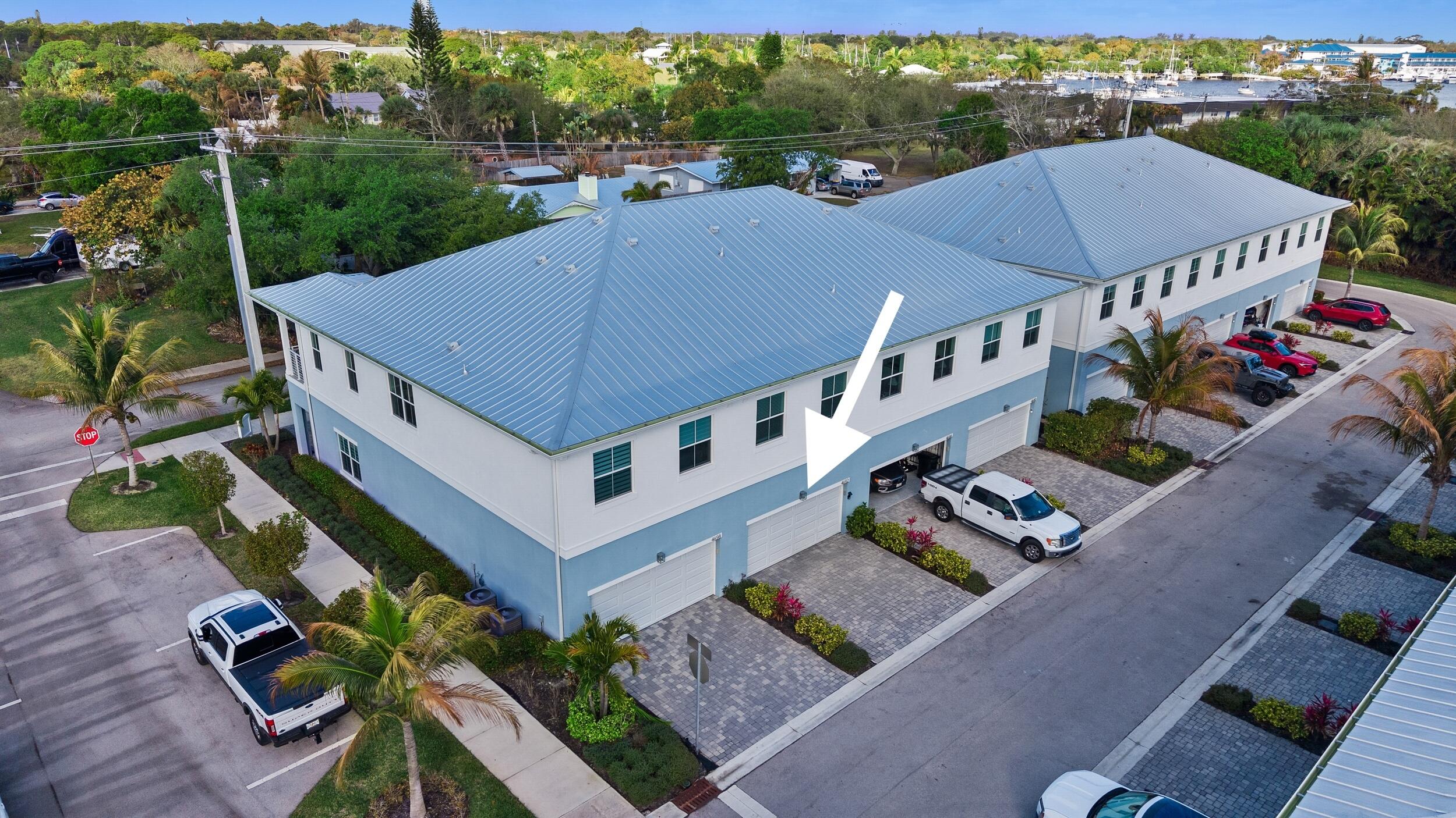 4692 Southeast Manatee Terrace Stuart, FL 34997 - Photo 33 of 47 an aerial view of multiple houses with a yard
