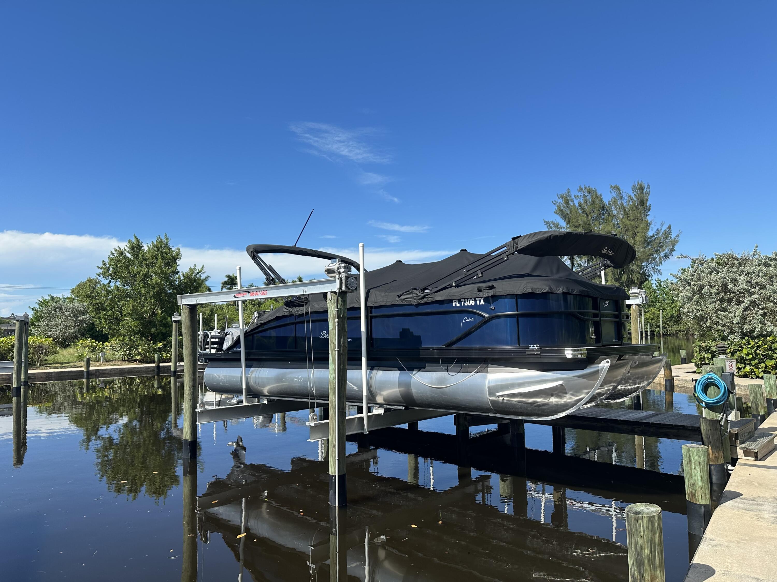 4692 Southeast Manatee Terrace Stuart, FL 34997 - Photo 45 of 47 a view of a chairs and table in the patio